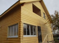 Брусовой дом обшитый фальшбревном